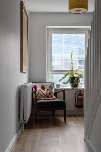 a room with a desk and a chair and a window at Holyrood Duplex 3-Bedroom Apartment in Edinburgh
