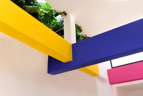 a colorful wall with a plant in a pot at Dar Syada Boutique Hotel Marrakech in Marrakech