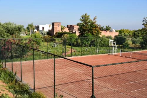 a tennis court with a net on top of it at Dar Syada Boutique Hotel Marrakech in Marrakech