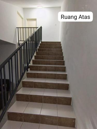 a stairway in a building with a stairway sidx sidx at Homestay AinulZahra in Seri Iskandar