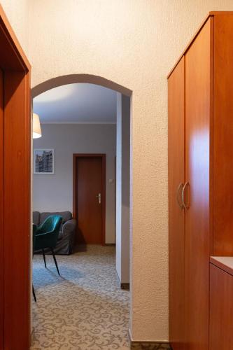 a hallway with an open door to a living room at Inza Guest House in Druskininkai