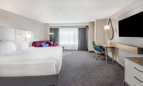 a hotel room with a large bed and a desk at Crowne Plaza Cleveland at Playhouse Square by IHG in Cleveland