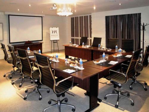a large conference room with a large table and chairs at Grand Mercure Bangalore - An Accor Brand in Bengaluru