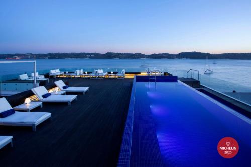 a swimming pool on the deck of a cruise ship at Altis Belem Hotel & Spa, a Member of Design Hotels in Lisbon
