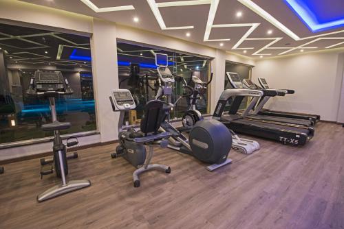 a gym with several treadmills and elliptical machines at Casa Mare Resort - ex, Royal Tulip Beach Resort in Port Ghalib