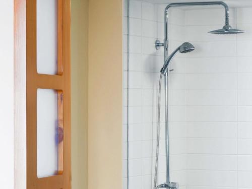 a shower in a bathroom with a shower head at Novotel Toronto Vaughan Centre in Vaughan