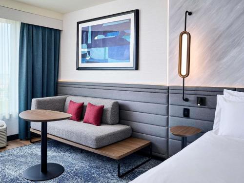a hotel room with a bed and a couch at Novotel Toronto Vaughan Centre in Vaughan