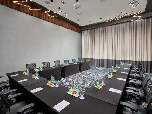 a conference room with long tables and chairs at Novotel Toronto Vaughan Centre in Vaughan
