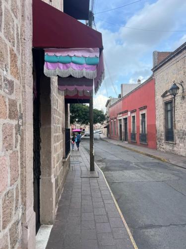 a building with awning on the side of a street at Hotel Bamboo Sauces Morelia in Morelia
