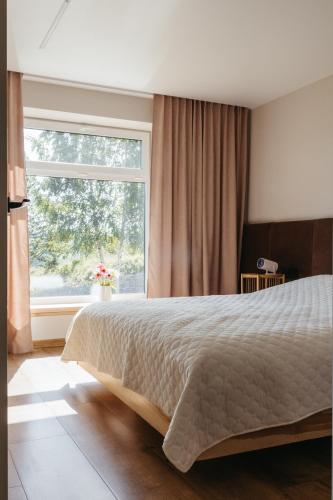 a bedroom with a large bed and a large window at Вирій in Slavske