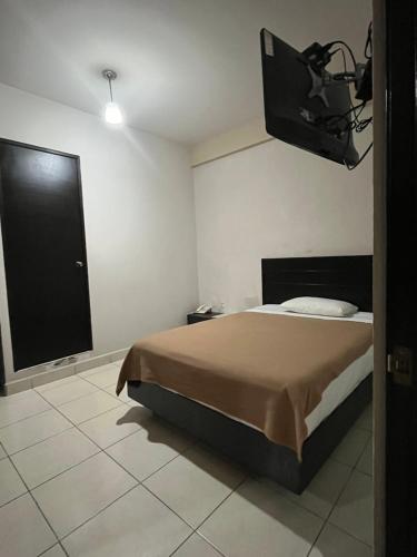 a bedroom with a bed and a large window at Hotel Bamboo Sauces Morelia in Morelia