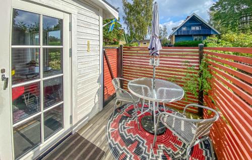 a patio with a table and chairs and an umbrella at Lovely Apartment In Borgholm With Wifi in Borgholm