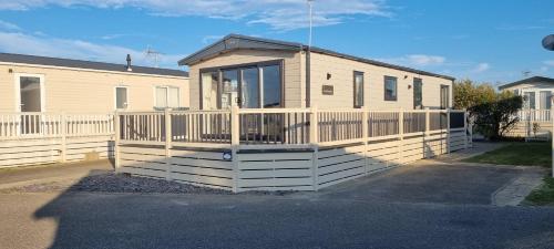 a small house with a porch and a fence at Platinum villa in Whitstable