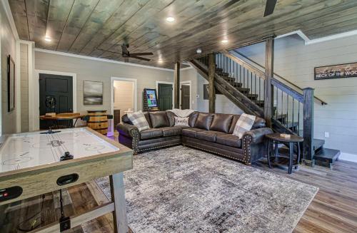 a living room with a couch and a table at Hilltop Haven By Avada Properties in Boyds Creek