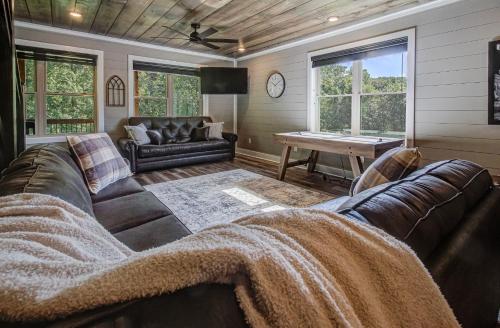 a living room with a couch and a table at Hilltop Haven By Avada Properties in Boyds Creek