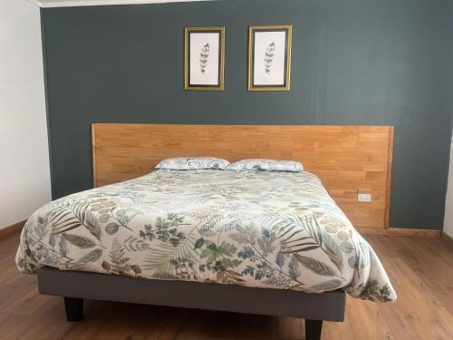 a bedroom with a bed with a blanket on it at Brisas de Puerto Varas in El Cerrillo