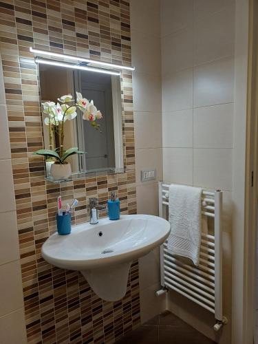 a bathroom with a white sink and a mirror at Stella Maris - Private Apartment in Bari