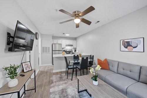 a living room with a couch and a table at Cozy Contemporary Stay I Pool & Gym I Free Parking in Spring Lake