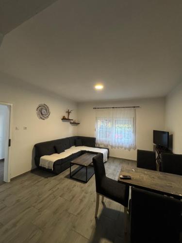 a living room with a couch and a table at Kuća za odmor Nikola Medjugorje in Čitluk