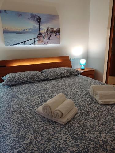 a bedroom with a bed with two towels on it at Stella Maris - Private Apartment in Bari