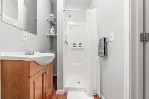 a white bathroom with a sink and a shower at Cozy Little Italy Apt Fast Wifi Pet Friendly in Cleveland