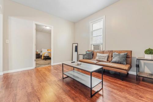 a living room with a couch and a table at Cozy Little Italy Apt Fast Wifi Pet Friendly in Cleveland