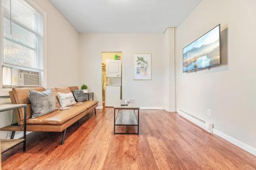 a living room with a couch and a table at Cozy Little Italy Apt Fast Wifi Pet Friendly in Cleveland