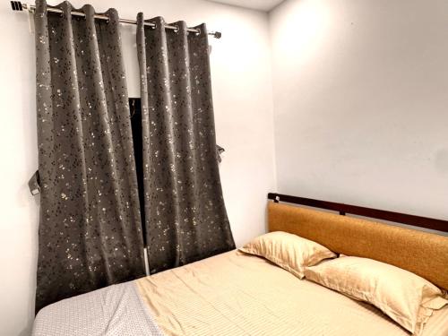a bedroom with a bed and a curtain at Vibes stay in in Hyderabad