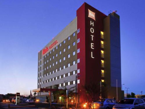 a hotel building with a sign on the side of it at Ibis Hermosillo in Hermosillo