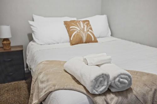 a white bed with towels on top of it at Cozy Little Italy Apt Fast Wifi Pet Friendly in Cleveland