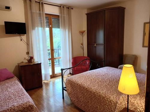 a bedroom with a bed and a chair and a window at Freetime in Perugia