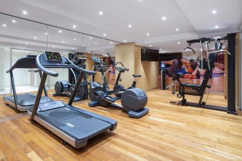 a gym with several exercise equipment in a room at Mercure Hotel Brussels Centre Midi in Brussels