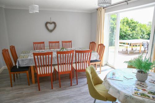 a dining room with a table and chairs at Home with HotTub near AltonTowers & Waterworld sot in Stoke on Trent