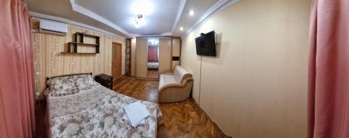 a small room with a bed and a television at Затишна 1 кімнатна квартира біля метро Дарниця in Kyiv