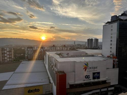 a view of a building with the sunset in the background at Luxur Skyline Germania en Bucaramanga in Estación El Salto