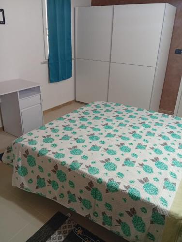 a bedroom with a bed with a quilt on it at Casa vacanze dell' Abbaddu 3 in Sassari