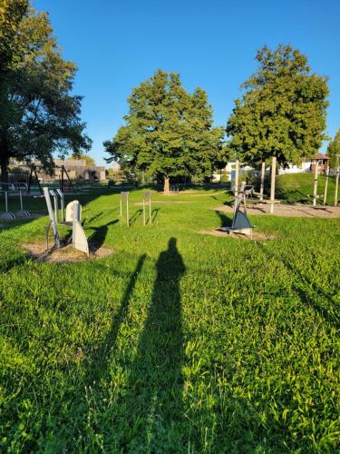 a shadow of a person standing in a park at Rana's B&B - Bed&Breakfast in Rust