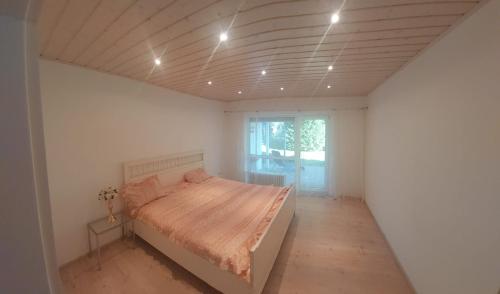 a bedroom with a bed in a white room at Gästehaus Virtuous Home in Pirmasens