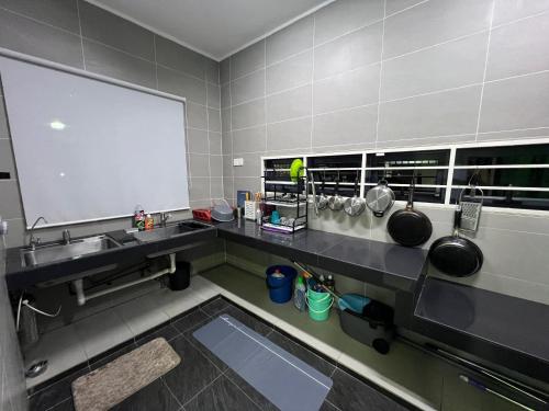 a kitchen with a sink and a large mirror at 5-15pax Ampang Homestay 5BR House Near KLCC in Ampang