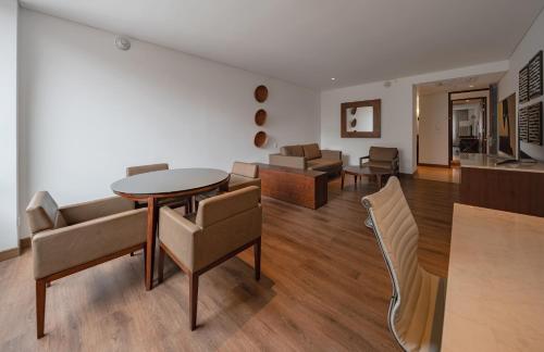 a living room with a table and chairs at Hotel Chico 97 By OxoHotel in Bogotá