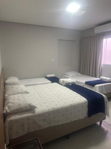 a bedroom with two beds and a window at Hotel Ledo in Bom Jesus da Lapa