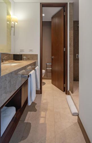 a bathroom with a sink and a counter with towels at Hotel Chico 97 By OxoHotel in Bogotá