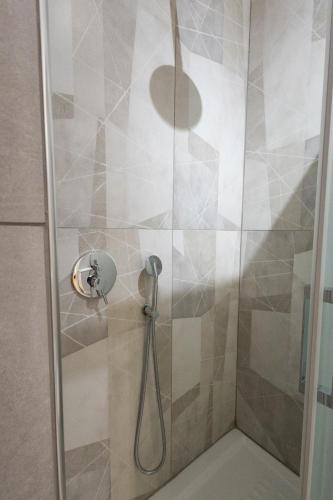 a shower with a shower head in a bathroom at Casa di Antonio in Rome