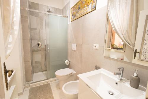 a bathroom with a toilet and a sink and a shower at Casa di Antonio in Rome