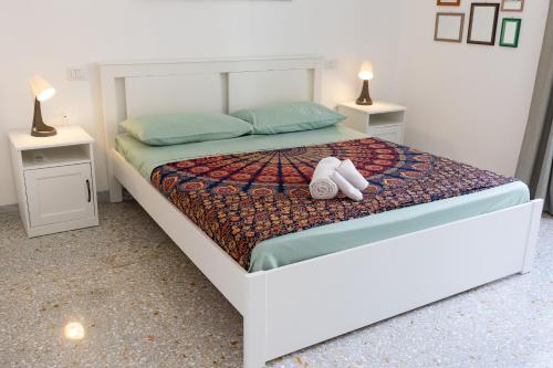 a white teddy bear sitting on a bed at Casa di Antonio in Rome