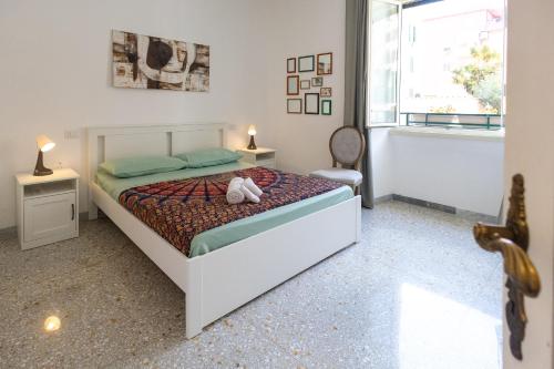 a bedroom with a bed and two tables and a window at Casa di Antonio in Rome