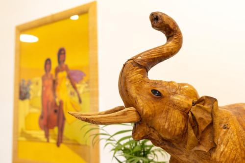 a wooden elephant statue in front of a building at Casa di Antonio in Rome