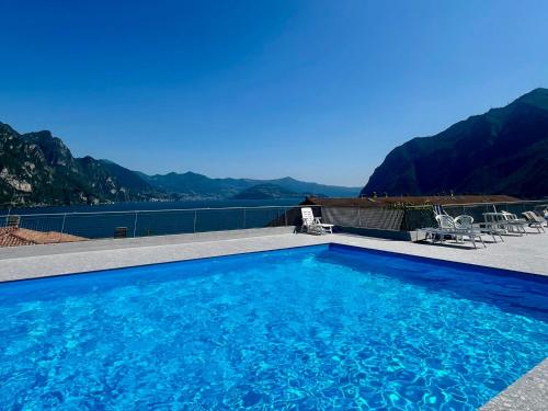 a swimming pool with a view of the mountains at Appartamento sul Lago con Terrazza Panoramica in Riva di Solto