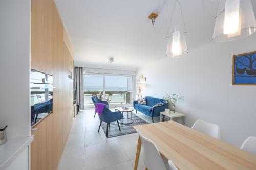 a kitchen and living room with a table and chairs at Aldis - beachfront in Ostend