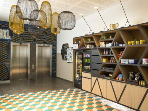 a grocery store with a checkerboard floor at Aparthotel Adagio Brussels Grand Place in Brussels